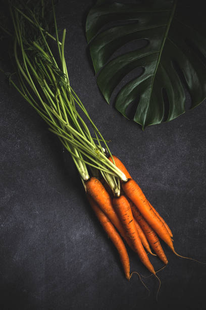 Fresh carrots on black background