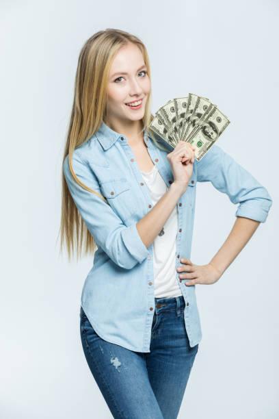 istock Woman holding dollar banknotes 655801424