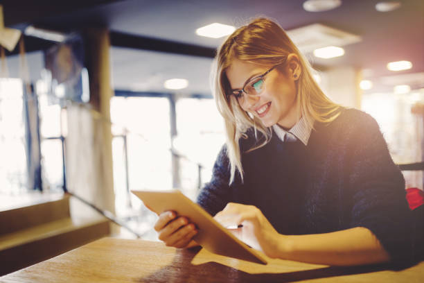istock Beautiful student relaxing and surfing on tablet 655802104