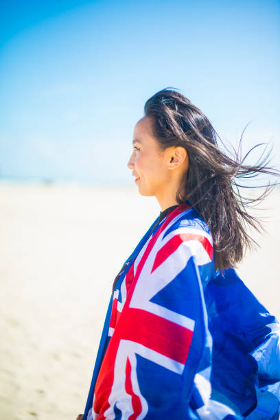 mixed race beautiful woman celebration citizenship on australian beach - australia australia day celebration flag imagens e fotografias de stock