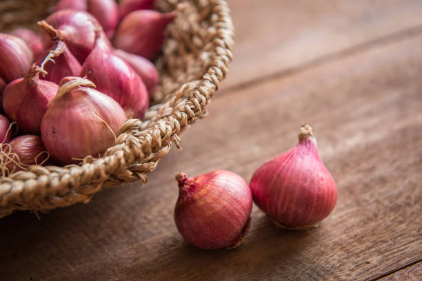 istock Red onion on a wooden table 655807094