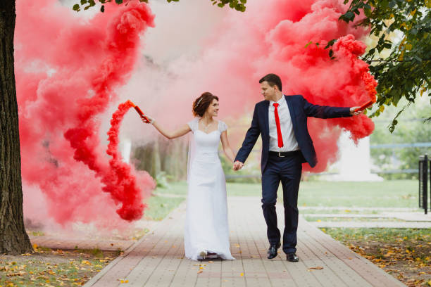 istock The bride and groom with the red colored smoke 655807746