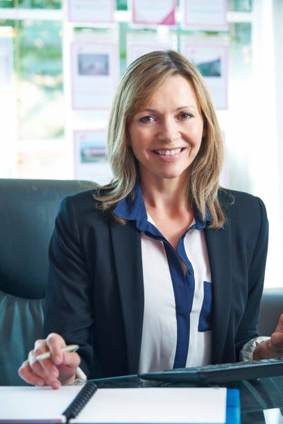 istock Female Estate Agent Working At Computer In Office 655807758