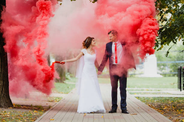 istock The bride and groom with the red colored smoke 655807782
