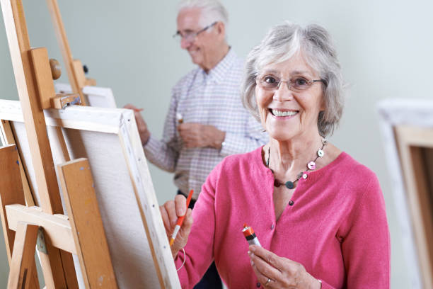 istock Seniors Attending Painting Class Together 655809924