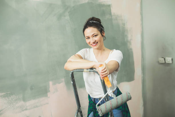 istock Playful young woman house painter 655810100