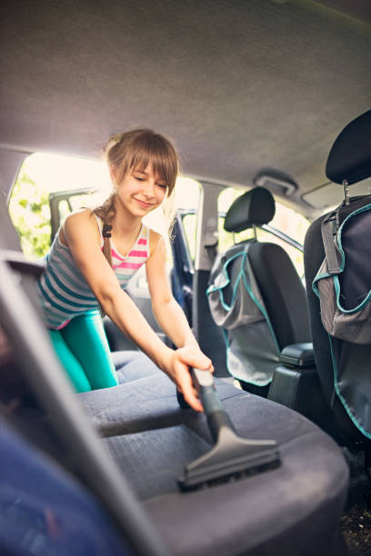 istock Little girl cleaning car interior 655811078