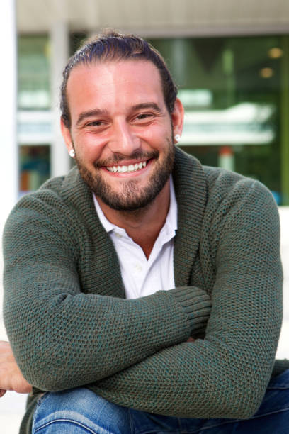 istock Man sitting with arms crossed smiling 655811258
