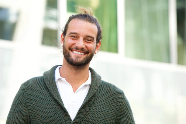 istock Smiling man with beard wearing green sweater 655811342