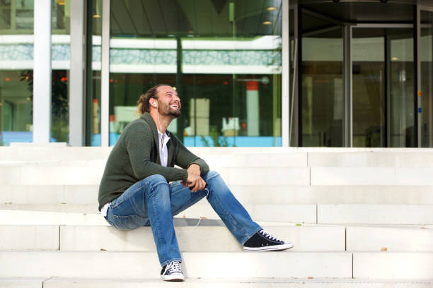 istock Man sitting on steps listening to music 655811368