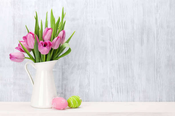 Easter eggs and pink tulips bouquet