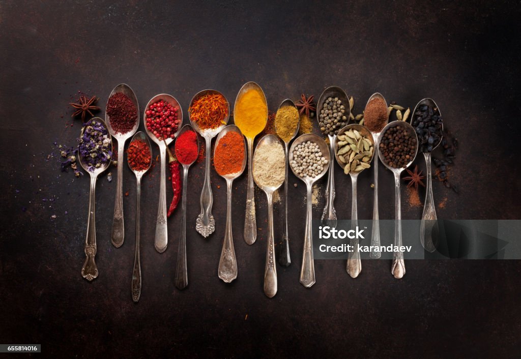 Various spices spoons Various spices spoons on stone table. Top view Spoon Stock Photo