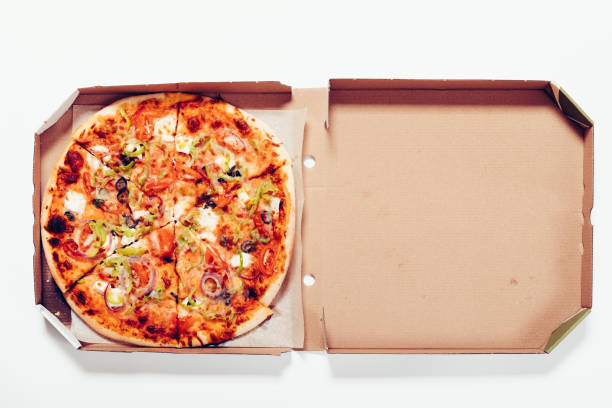 istock Top view of a pizza in a box on a white table 655814532