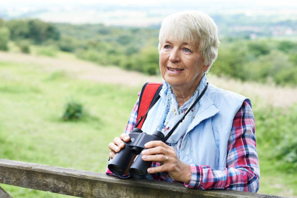 istock Senior Woman On Walk With Binoculars 655815352