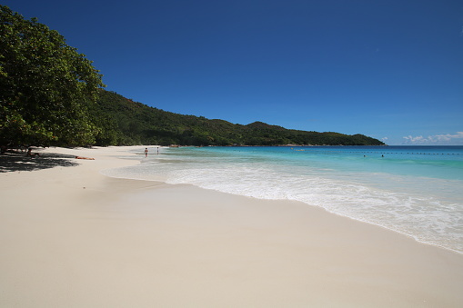The white sandy beach of Anse Lazio is popular for its beautiful landscape. People enjoy swimming an sunbathing. The famous beach is located in the northwest of Praslin Island. Red granite rocks are part of the scenery.