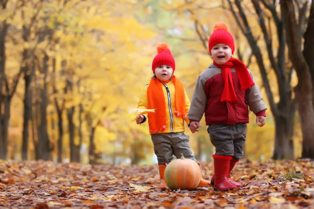 istock kids in autumn park with pumpkin 655819848