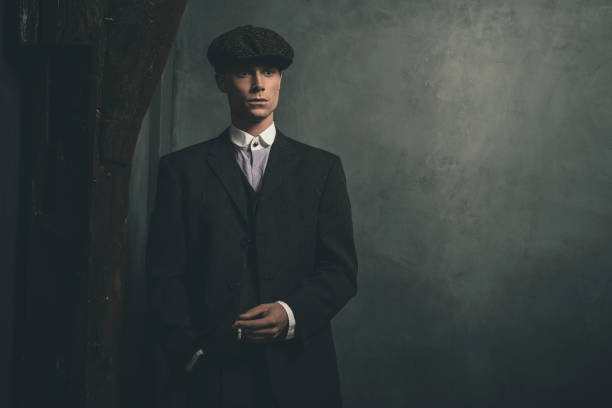istock Retro 1920s english gangster standing with cigarette. 655820640