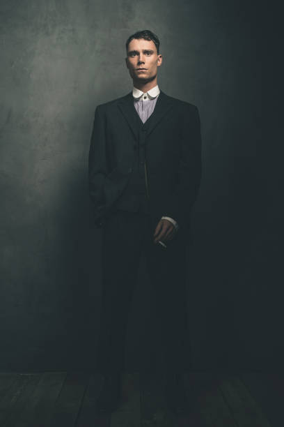 istock Retro 1920s english gangster standing with cigarette. 655820680