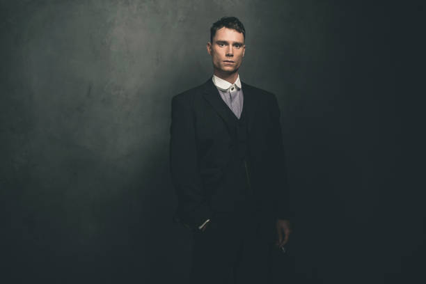 istock Retro 1920s english gangster standing with cigarette. 655820718
