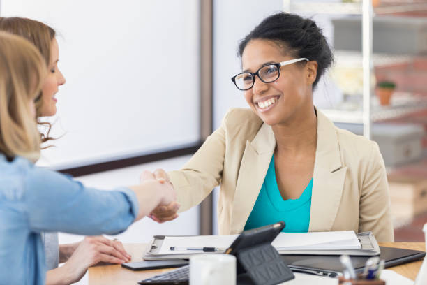 istock Smiling female fashion designer greets client 655839770