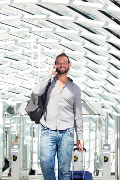 istock Handsome travel man talking on phone with luggage 655839790