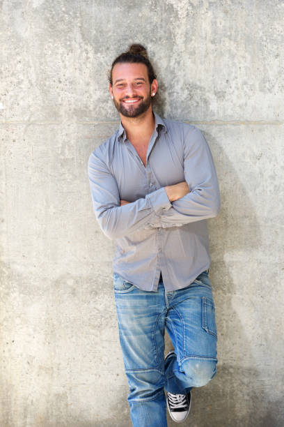 istock Handsome man smiling with arms crossed 655840030