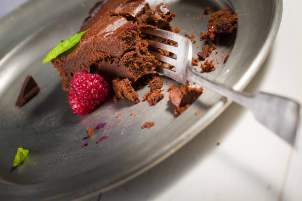 istock Chocolate brownie with raspberries and leaf of mint. 655840176