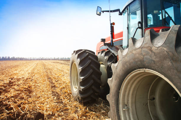 istock Modern red tractor in the field close-up. 655846948