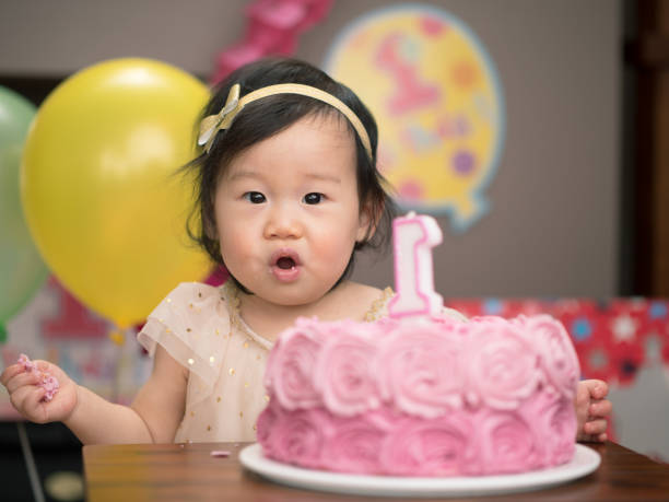 istock baby girl celebrate her first birthday 655848352