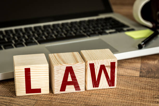 istock Law written on a wooden cube in a office desk 655858042
