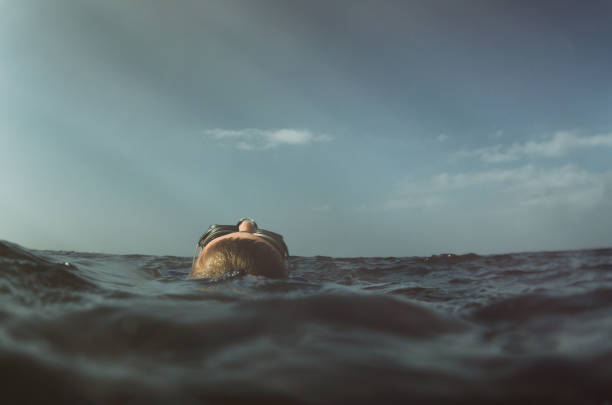 istock Child resting and floating in the ocean 655869380