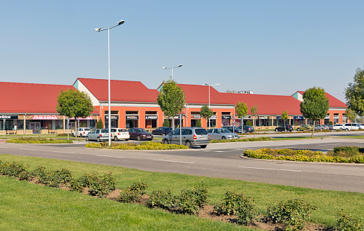 Cars parked in front of M3 Shopping Mall just by the M3 highway leading to Debrecen and Nyiregyhaza. Polgar is a city in the administrative county of Hajdu-Bihar in eastern Hungary.