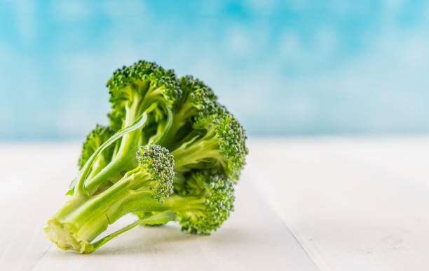 Broccoli Florets with Copy Space on Right Broccoli Florets with Copy Space on Right over table top broccoli crowns stock pictures, royalty-free photos & images