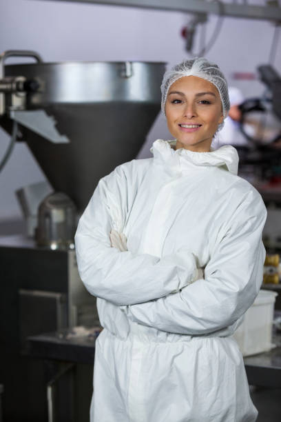 istock Female butcher standing with arms crossed 655873374