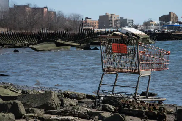 Scrap of shopping cart in a cemetery of boats in Coney Island, New York City