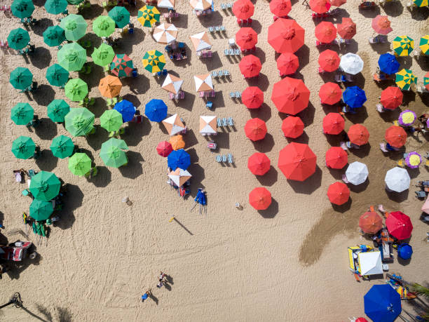 Top View of Umbrellas in a Beach Top View of Umbrellas in a Beach beach umbrella aerial stock pictures, royalty-free photos & images