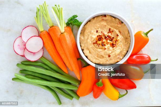 Hummus With Fresh Vegetables Above View On White Marble Stock Photo - Download Image Now