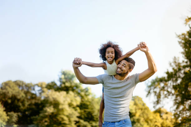 istock Father carrying daughter on back outdoors 655893702