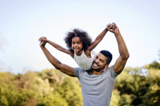 istock Father carrying daughter on back outdoors 655893714