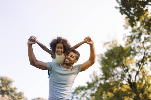 istock Father carrying daughter on back outdoors 655893722
