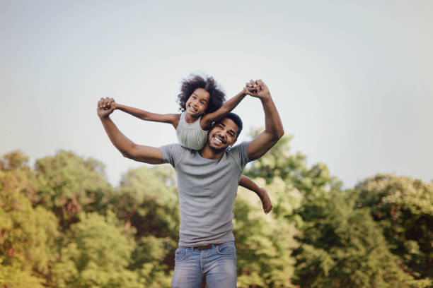 istock Father carrying daughter on back outdoors 655893726