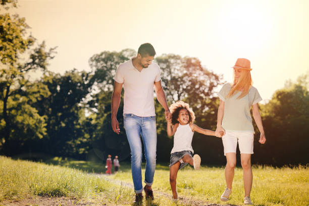 istock Playful faimly outdoors walking and smiling 655893846