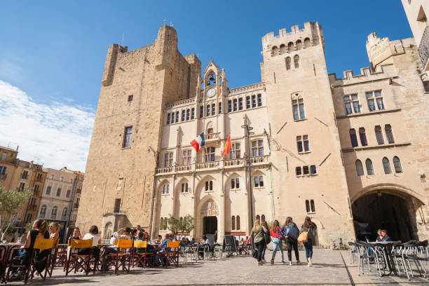 Streets, scenes and architecture Narbonne, France. Typically European town square, Place Hotel de Ville, surrounded by bars, cafes and retail with people enjoying the ambience and sun of  urban life, scenes and architecture Narbonne, France. narbonne stock pictures, royalty-free photos & images