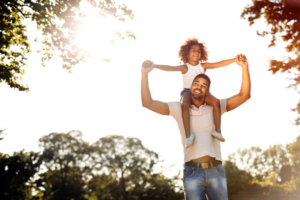 istock Father carrying daughter on back outdoors 655894086