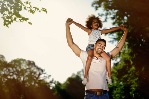 istock Father carrying daughter on back outdoors 655894956