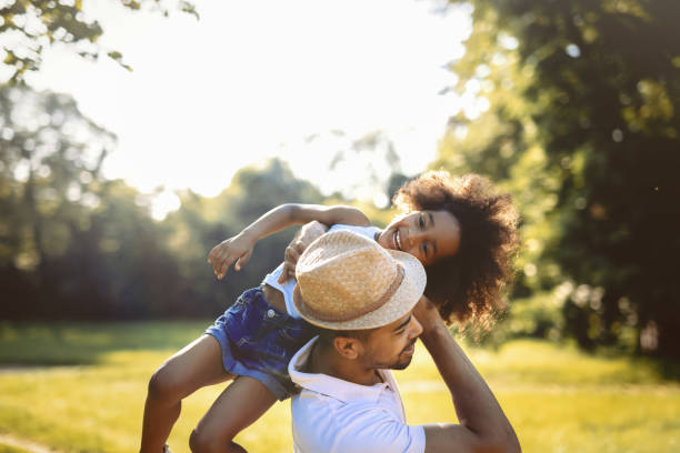 istock Father carrying daughter on back outdoors 655896162