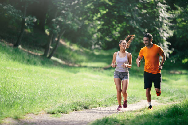 istock Couple jogging and running outdoors in nature 655896284