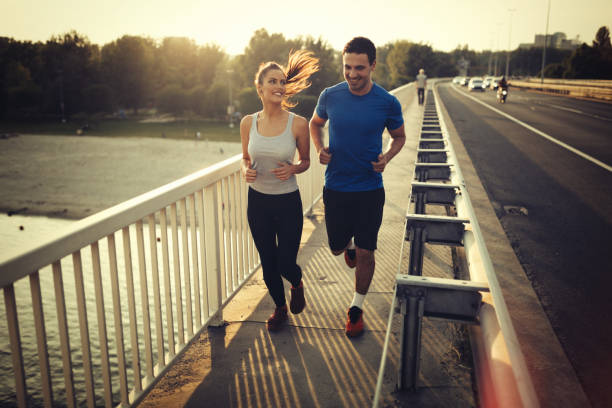istock Athletic couple jogging together outdoors 655897148