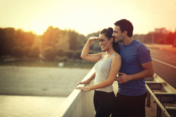 istock Athletic couple jogging together outdoors 655897190