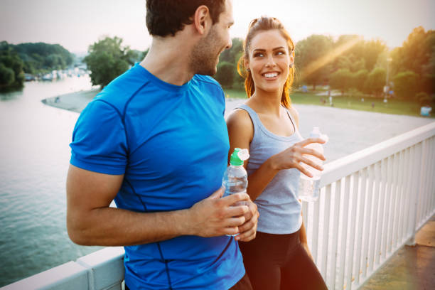 istock Athletic couple jogging together outdoors 655897300